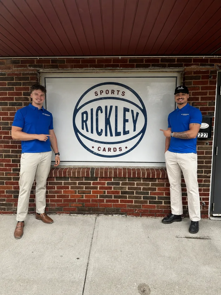 Payton and Cole, founders of PC Premium Coating, in company polos outside a local Omaha storefront
